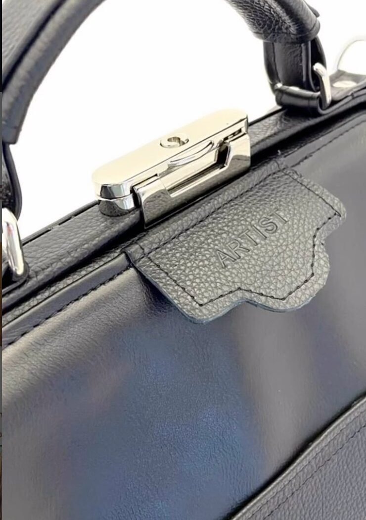 Polished hardware and embossed ARTIST tag
